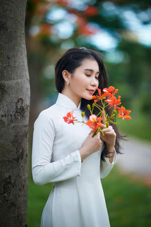 Ho Chi Minh City, Vietnam: a beautiful Vietnamese student in white ao daiの写真素材