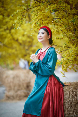 Ho Chi Minh City, Vietnam: Beautiful Vietnamese girl in traditional clothes to celebrate the lunar new yearの写真素材