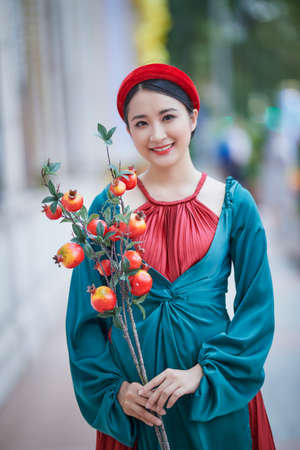 Ho Chi Minh City, Vietnam: Beautiful Vietnamese girl in traditional clothes to celebrate the lunar new yearの写真素材