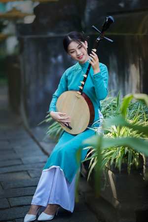 Ho Chi Minh city, Viet Nam: Vietnamese girl going to pagoda in ao daiの写真素材