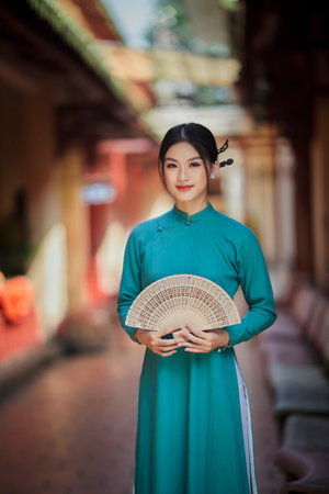Ho Chi Minh city, Viet Nam: Vietnamese girl going to pagoda in ao dai