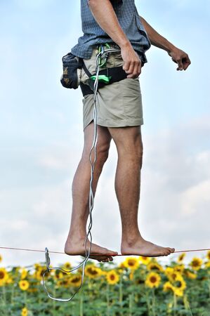 a tightrope walker on a wireの写真素材