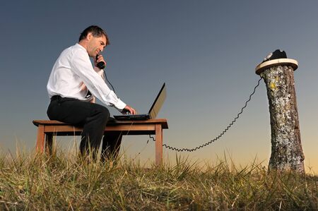 a businessman who phone in the countrysideの写真素材