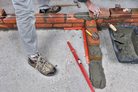 construction of a brick wall by a bricklayer              のeditorial素材