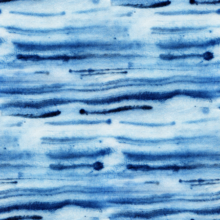 Seamless tie-dye pattern with stripes of indigo color on white silk. Hand painting fabrics - nodular batik. Shibori dyeing.の写真素材