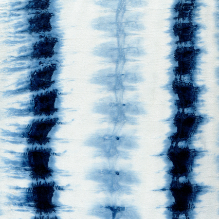 Tie-dye pattern of indigo color on white silk. Hand painting fabrics - nodular batik. Shibori dyeing.の写真素材
