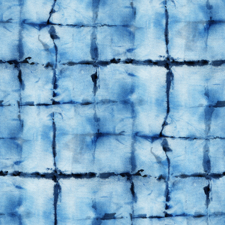 Seamless tie-dye pattern of indigo color on white silk. Hand painting fabrics - nodular batik. Shibori dyeing.の写真素材