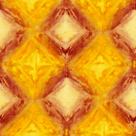 Seamless tie-dye pattern of yellow and brown  color on white silk. Hand painting fabrics - nodular batik. Shibori dyeing.の写真素材