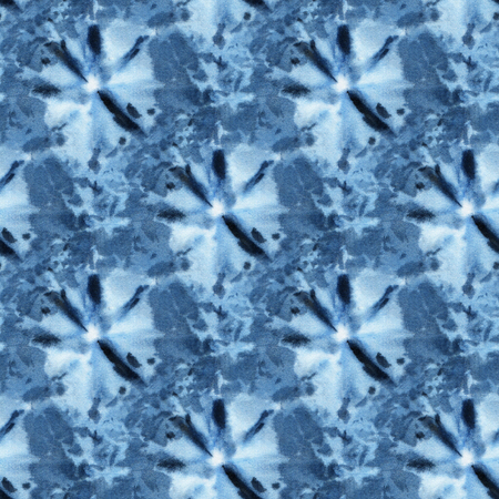 Seamless tie-dye pattern of indigo color on white silk. Hand painting fabrics - nodular batik. Shibori dyeing.の写真素材