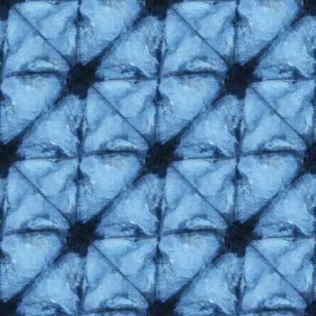 Seamless tie-dye pattern of indigo color on white silk. Hand painting fabrics - nodular batik. Shibori dyeing.の写真素材
