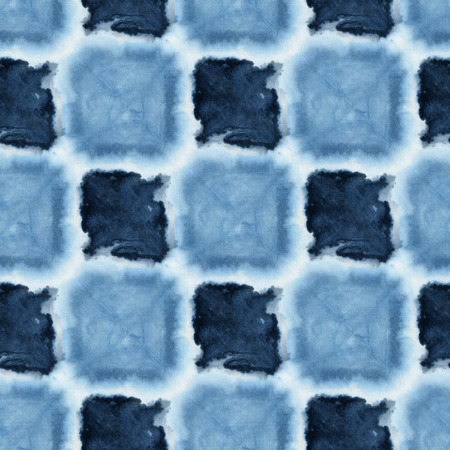 Seamless tie-dye pattern of indigo color on white silk. Hand painting fabrics - nodular batik. Shibori dyeing.の写真素材