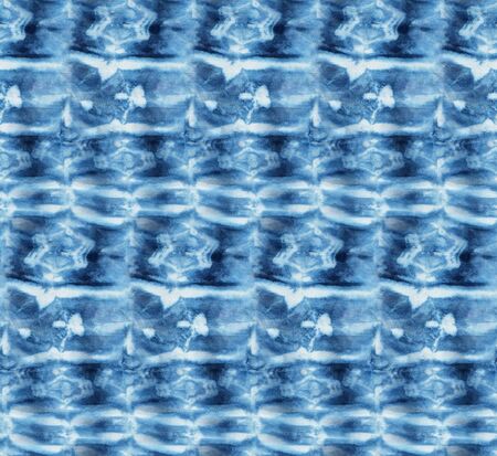 Seamless tie-dye pattern of indigo color on white silk. Hand painting fabrics - nodular batik. Shibori dyeing. の写真素材