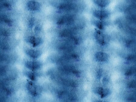 Seamless tie-dye pattern of indigo color on white silk. Hand painting fabrics - nodular batik. Shibori dyeing.の写真素材