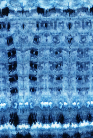 Tie-dye pattern of indigo color on white silk. Hand painting fabrics - nodular batik. Shibori...