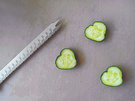 Cucumber hearts with a knifeの写真素材