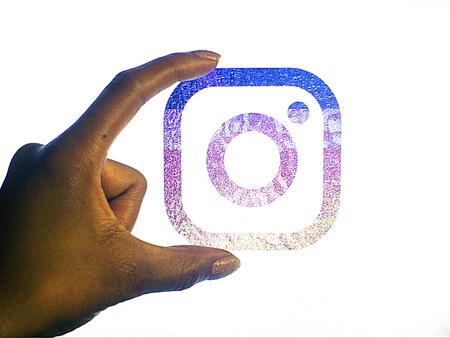 New instagram logo held by a hand on a white backgroundのeditorial素材