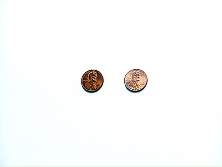 Overhead shot of two pennies on white backgroundの写真素材