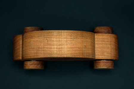 Wooden toy car on a black background. View from above. cherry wood, isolated. top view. handmadeの写真素材