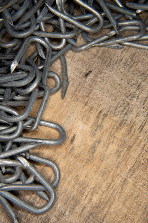 border made from pile of heavy barbed wire staples for construction and carpentryの写真素材