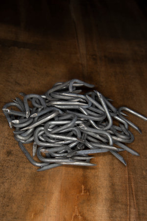 pile of heavy barbed wire staples for construction and carpentry