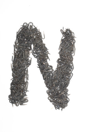 artistic isolated Letter N made from steel staples isolated on a white background write, font, type style,の写真素材