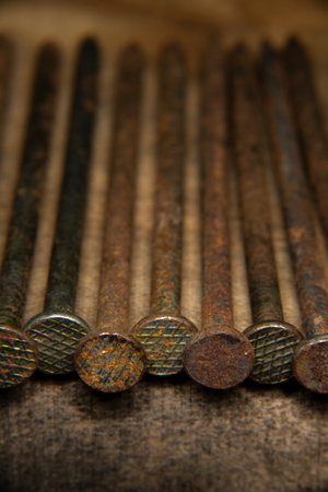 old rusty, 16 penny nail heads, line of heavy penny nails for construction and carpentry, building, creating, antique, old, grandfathers building tools, wood and nail backgroundの写真素材