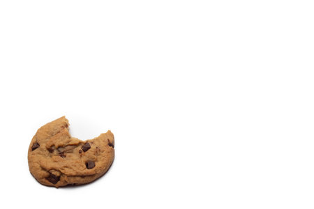 close up of chocolate chip cookie on white background with copy space, bakery, sweet dessert, with bite missingの写真素材