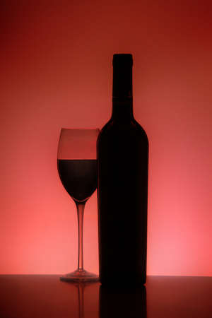 Silhouette of a glass and Bottle of red wineの写真素材