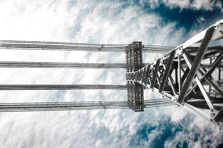 electric power lines tower and high voltage cablesの写真素材