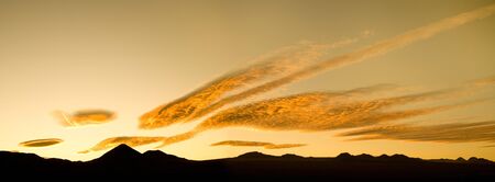 Sunrise in the Altiplano (High Andean plateau) with silhouette of Andes Mountain Range and...