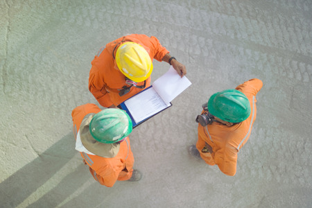 Workers of a copper mine reviewing a sheet