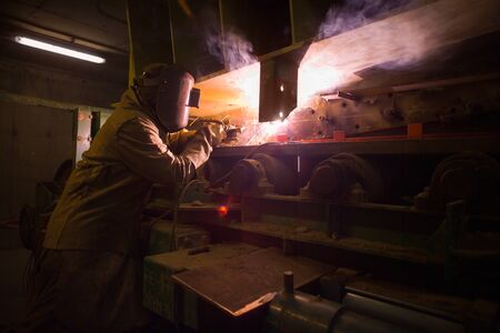 Welder repairing machinery at the plant of a Copper Mine in Chileの写真素材