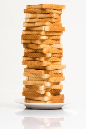 Tower of toasted bread against a white backgroundの写真素材