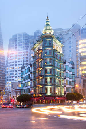 San Francisco, California, United States - Light trails at Columbus Avenue with Sentinel building and Transamerica Pyramid Buildingat at the back.のeditorial素材