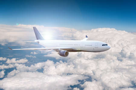 Passenger airplane on flight over the clouds.