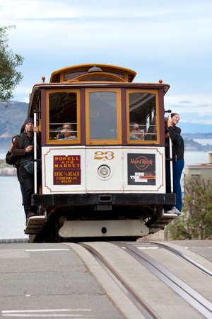 San Francisco, California, United States - Tourists on traditional Cable car at Russian Hill...