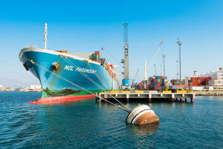 Iquique, Tarapaca Region; Chile - Containers being loaded in a cargo ship at the port of Iquique.のeditorial素材