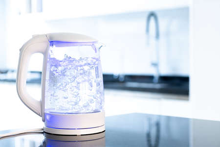 Boiling water inside an electric kettle at a modern kitchenの写真素材