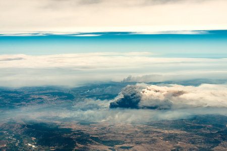 Aerial view of a big column of smoke from forest fire in southern Chileの写真素材