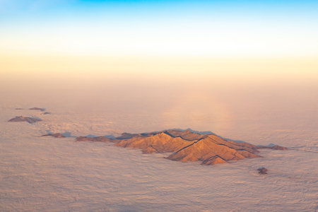 Aerial view of the top of a mountain rising above the cloudsの写真素材