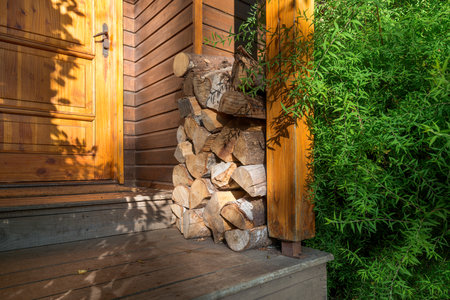 Stack of firewood outside a cabin.の写真素材
