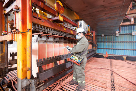 Calama, Antofagasta Region, Chile - Workers washing copper cathodes at an electrowinning plant in a copper mine.のeditorial素材