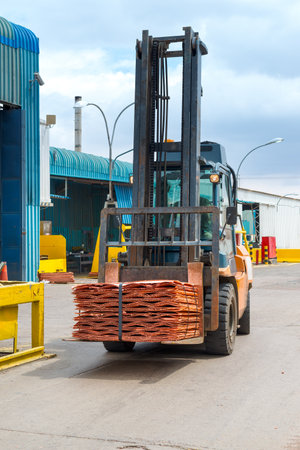 A forklift transporting copper cathodes at the plant of a copper mine.の写真素材