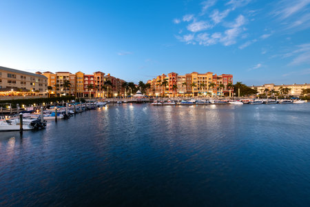 Naples, Florida, USA - Twilight settles on Naples with waterfront buildings and boats under a clear sky.のeditorial素材