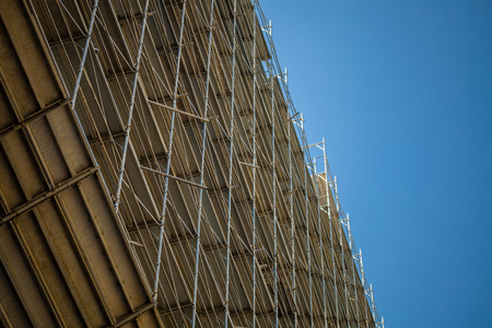 Building under construction, metal scaffolding and skyのeditorial素材