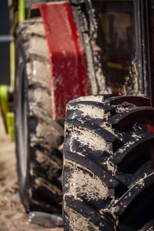 Color picture of an dirty tractor on a field  Closeup