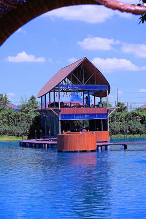 Two storeys pavilion over blue water on blue sky background 2の写真素材