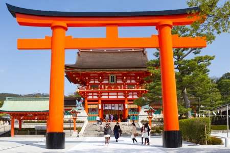 Kyoto, Japan - March 19, 2013: A giant torii gate in front of the Romon Gate at Fushimi Inari Shrine's entrance. Fushimi Inari Shrine is the head shrine of Inari, located in Fushimi-ku, Kyoto, Japan. It is famous for its thousands of vermilion torii gatesのeditorial素材