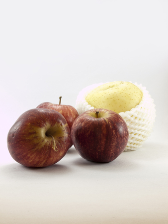 The red apples and the chinese pear on white backgroundの写真素材
