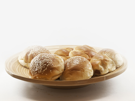 The pile of breads in the wooden dish in highkey lighting.の写真素材